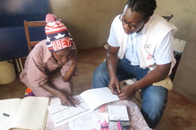 MSF nurse mentor, Tinashe Mbirimi (right) mentoring a village health worker, Rinet Zhou on how to register people living with HIV (PLHIV) to collect antiretroviral treatment using the Out of Facility Community ART Distribution (OFCAD) model in Mwenezi, Zimbabwe.