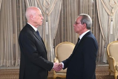 Tunisia President Kais Saied, left, during the swearing-in ceremony with new Prime Minister Ahmed Hachani, right